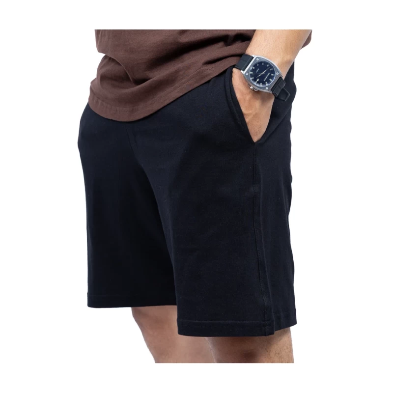 Close-up of a person wearing black KTM CTY Cloud-160 shorts keeping hand in pocket