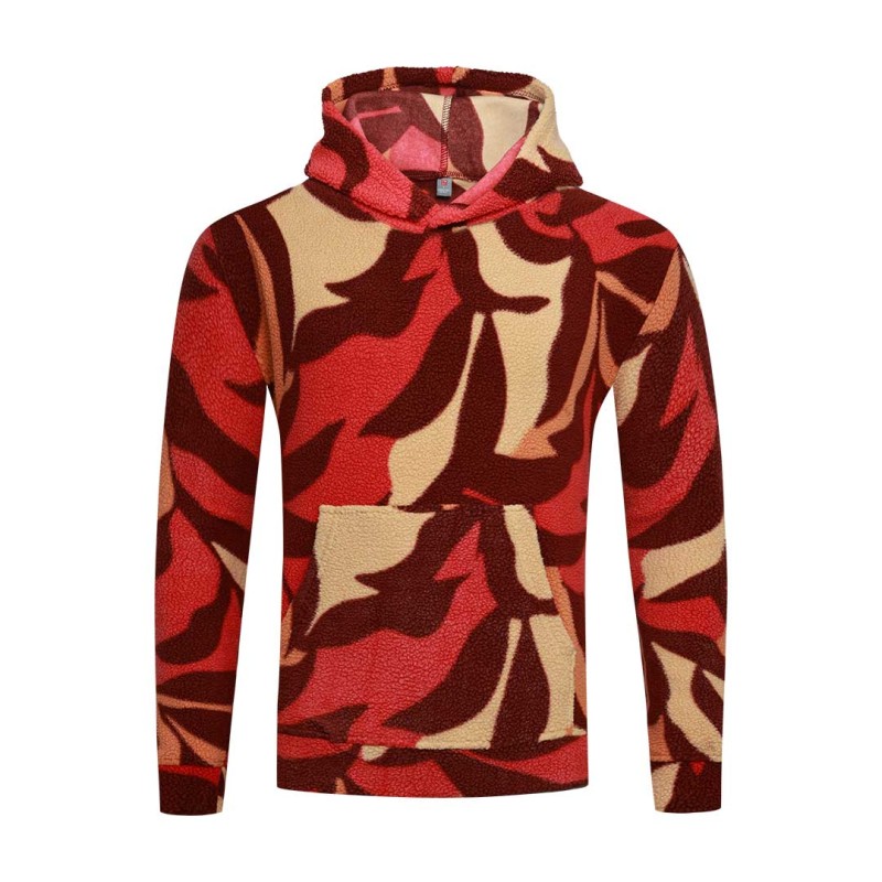 Model styling the KTM CTY Oversize Emberprint Sherpa Hoodie, featuring a warm, textured fleece with an earthy brown, green, and cream abstract pattern, oversized fit, with her hands in the front kangaroo pocket 1