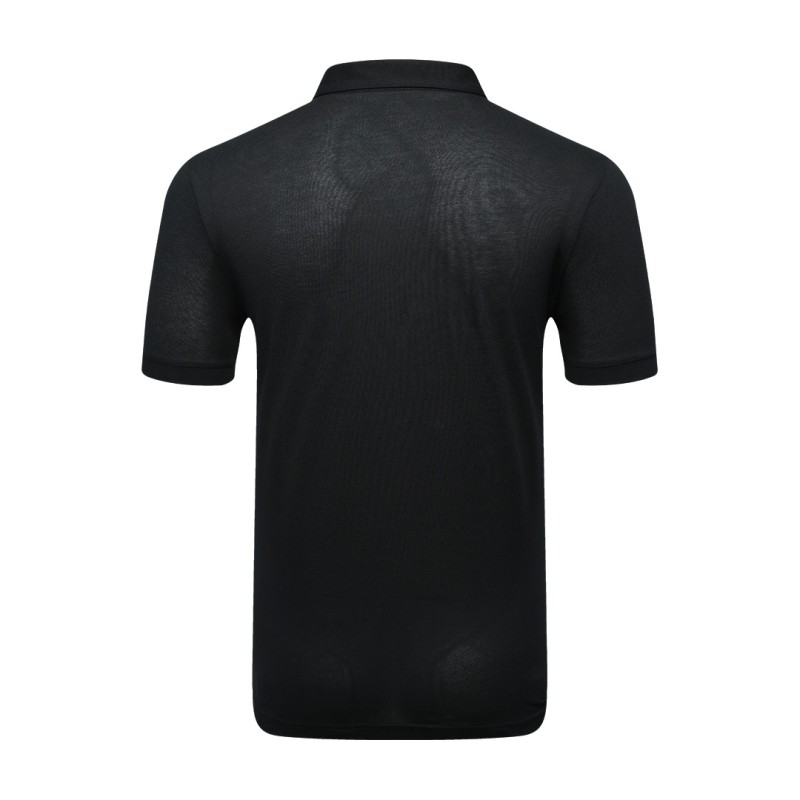 A man styling the forest green KTM CTY Pulse athletic polo tshirt, featuring a classic buttoned collar and short sleeves, paired comfortably with casual grey trousers 1