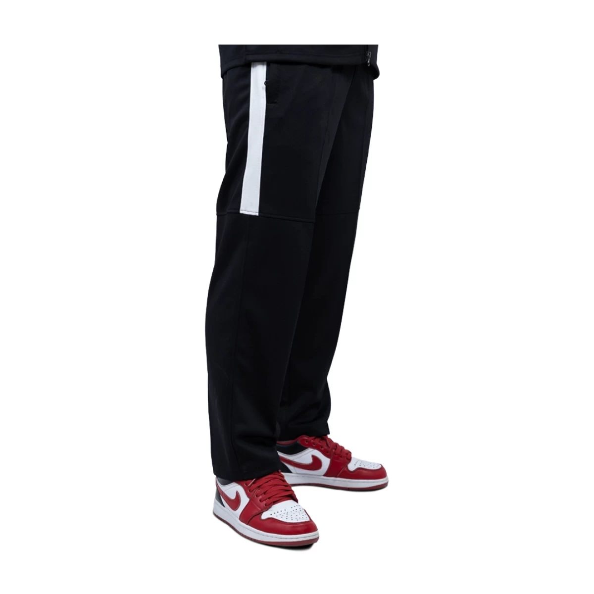 close-up of a person wearing black KTM CTY Strike Track Trousers featuring a bold white side stripe on the upper leg 1