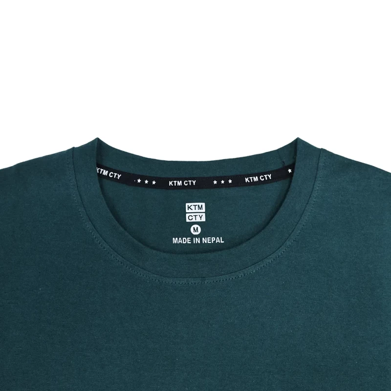 Two models showcasing casual loungewear tshirt. A woman in a light grey long-sleeve crewneck t-shirt and matching shorts stands next to a man wearing a dark green long-sleeve tshirt and black shorts 2
