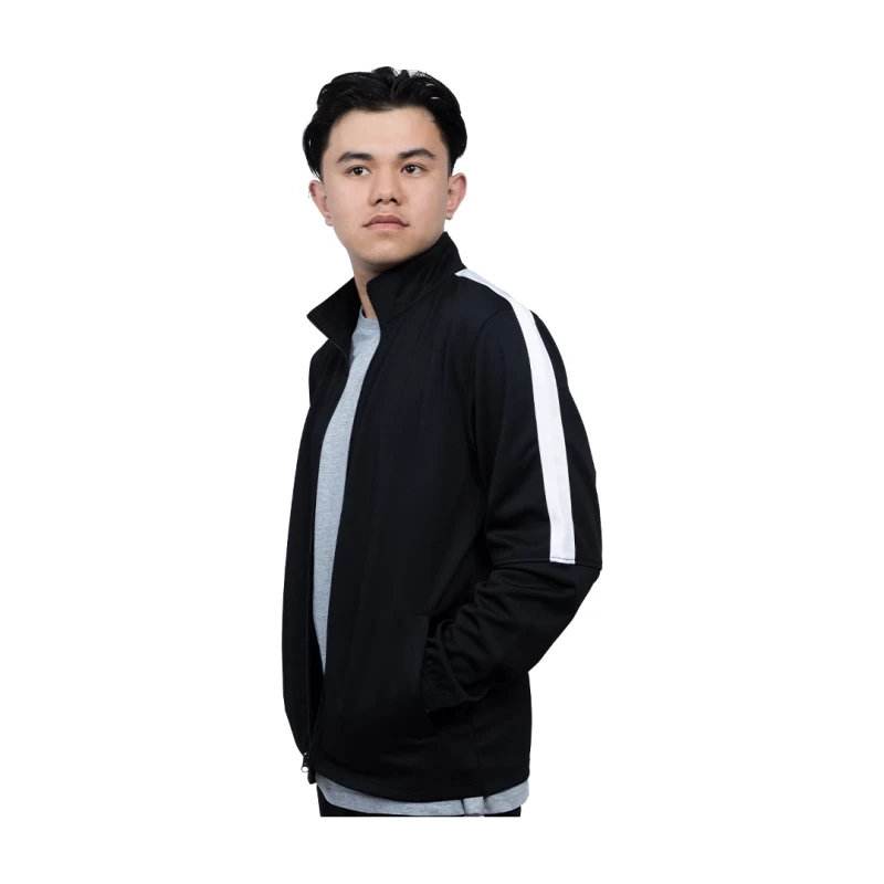 A female and male model standing back-to-back against a white background, wearing matching KTM CTY Strike track jackets with a bold white stripe down the sleeves. The woman is wearing a black track jacket and the man is wearing a grey track jacket. 1