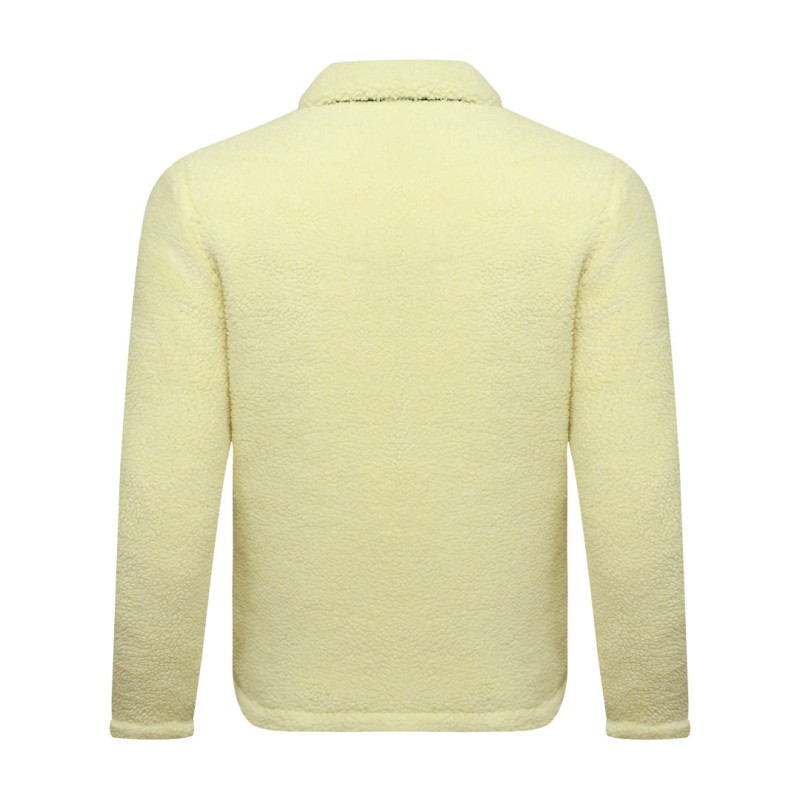 A model wearing a cream-colored sheep polyfiber unisex winter jacket featuring a classic fold-down collar, a full front zipper and hands resting in the side pockets 3