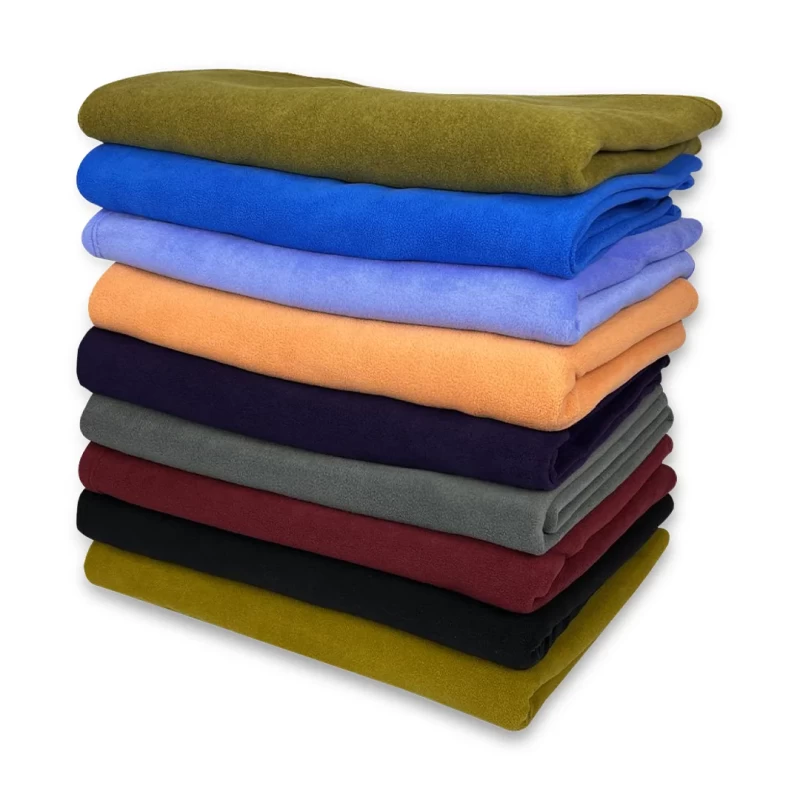 Cozy and soft KTMCTY Single Layer Fleece blankets, stacked high to show multiple color options for your bedroom or living room
