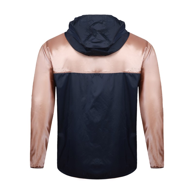 Front view of a male model styling a vibrant red and blue color-block lightweight windcheater jacket. This casual Unisex Windbreaker Jacket features a full zipper and a protective hood, making it a great outer layer for summer wear jacket. 9