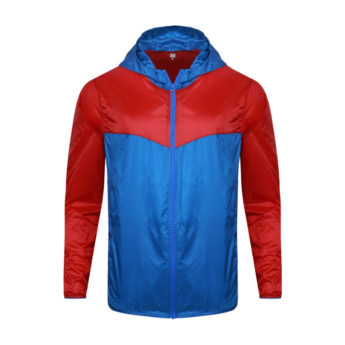 Front view of a male model styling a vibrant red and blue color-block lightweight windcheater jacket. This casual Unisex Windbreaker Jacket features a full zipper and a protective hood, making it a great outer layer for summer wear jacket. 1