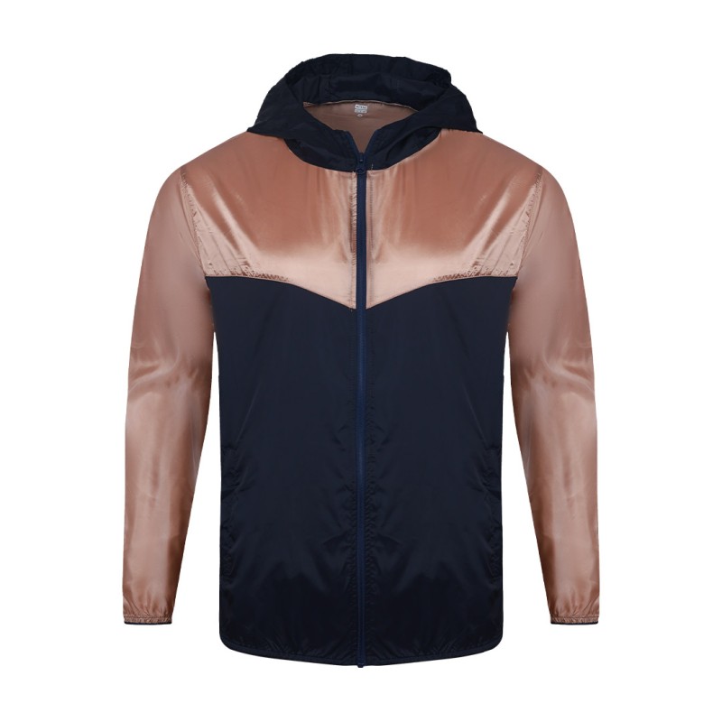 Front view of a male model styling a vibrant red and blue color-block lightweight windcheater jacket. This casual Unisex Windbreaker Jacket features a full zipper and a protective hood, making it a great outer layer for summer wear jacket. 2