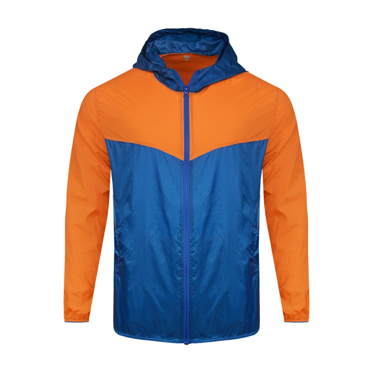 A smiling male model wearing the lightweight SkyShield Windcheater Jacket, featuring a bold red and bright blue color-block design, a full front zipper and an adjustable hood 0
