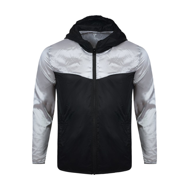 A smiling male model wearing the lightweight SkyShield Windcheater Jacket, featuring a bold red and bright blue color-block design, a full front zipper and an adjustable hood 3